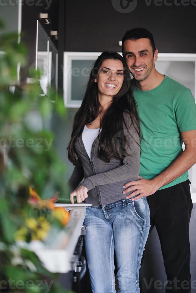 young couple have fun in modern kitchen photo