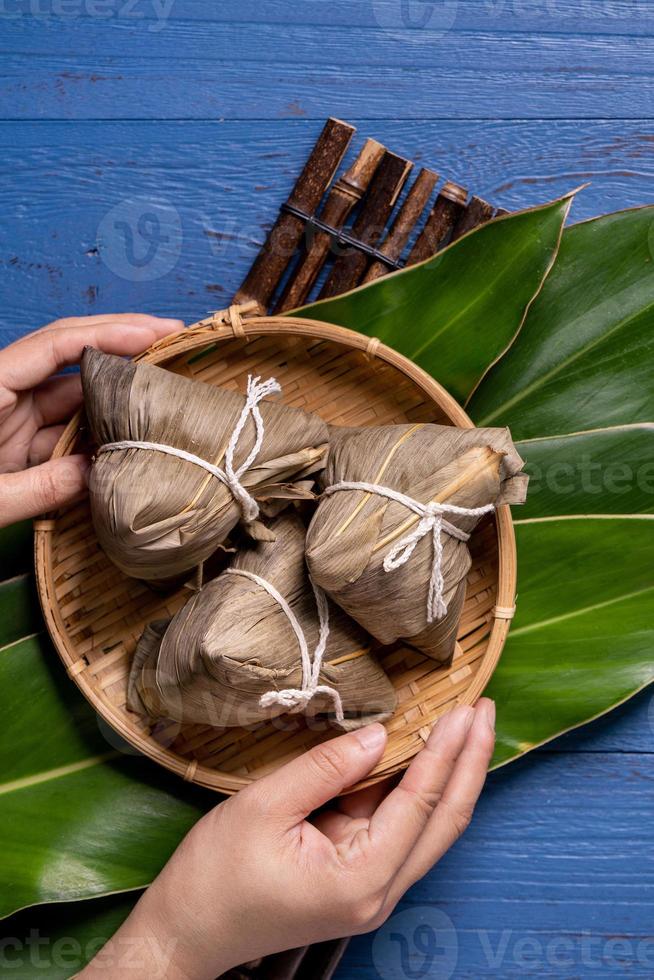 zongzi - Dragon Boat Festival concept Rice dumpling, traditional Chinese food on blue wooden background for Duanwu Festival, top view, flat lay design concept. photo