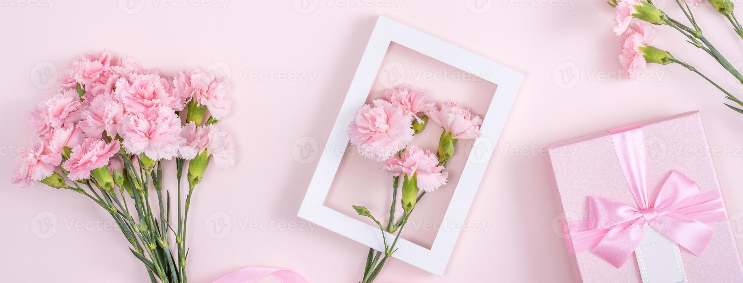 Mother's Day, Valentine's Day background design concept, beautiful pink carnation flower bouquet on pastel pink table, top view, flat lay, copy space. photo