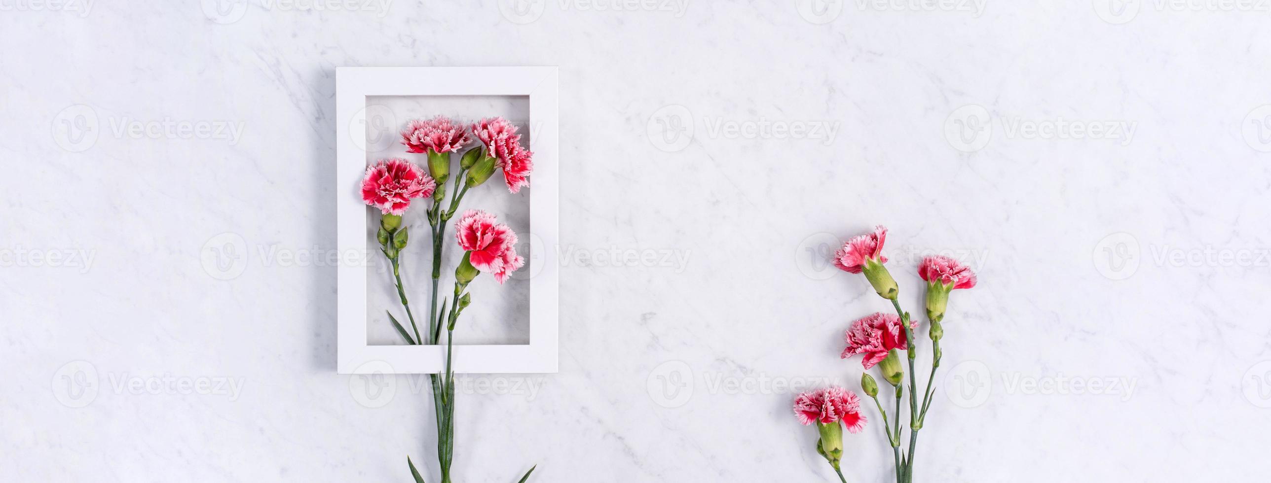 Mother's Day, Valentine's Day background design concept, beautiful pink, red carnation flower bouquet on marble table, top view, flat lay, copy space. photo