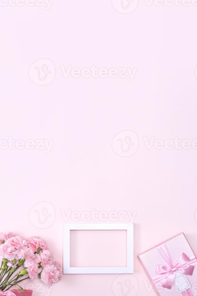 Mother's Day, Valentine's Day background design concept, beautiful pink carnation flower bouquet on pastel pink table, top view, flat lay, copy space. photo