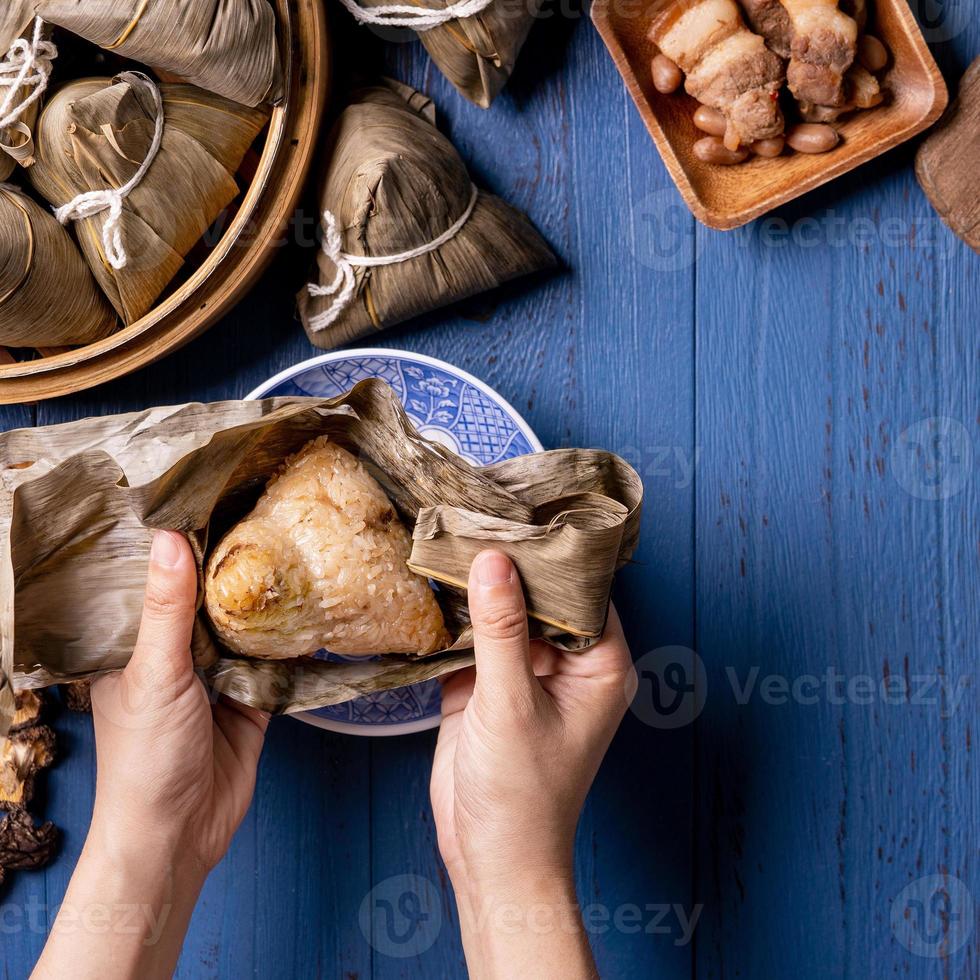 zongzi - Dragon Boat Festival concept Rice dumpling, traditional Chinese food on blue wooden background for Duanwu Festival, top view, flat lay design concept. photo