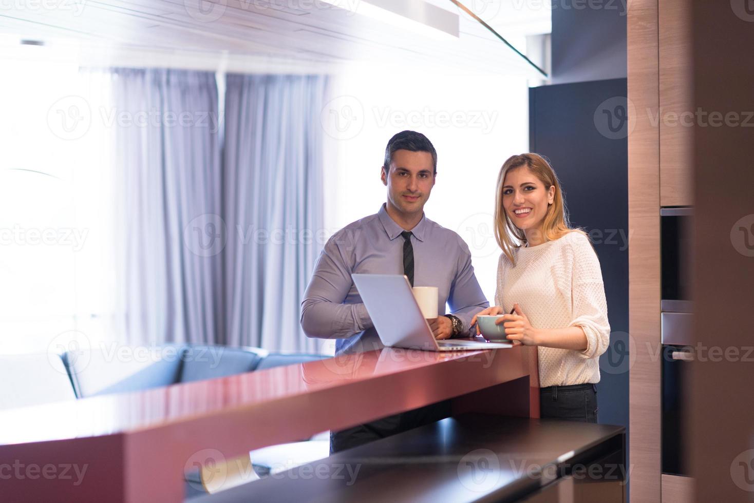 A young couple is preparing for a job and using a laptop photo