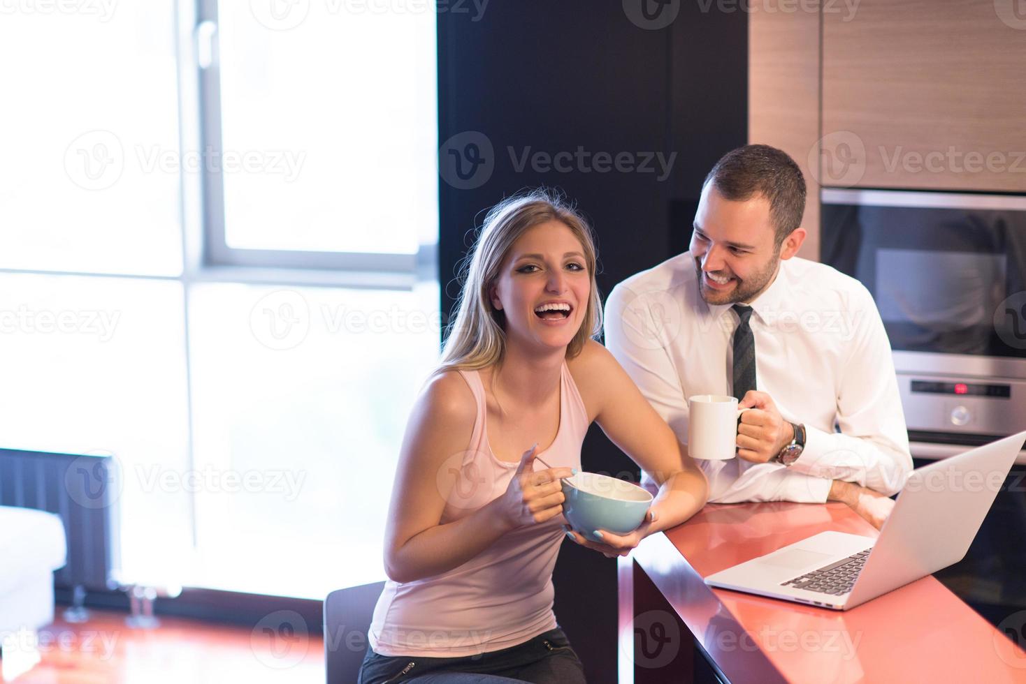 A young couple is preparing for a job and using a laptop photo