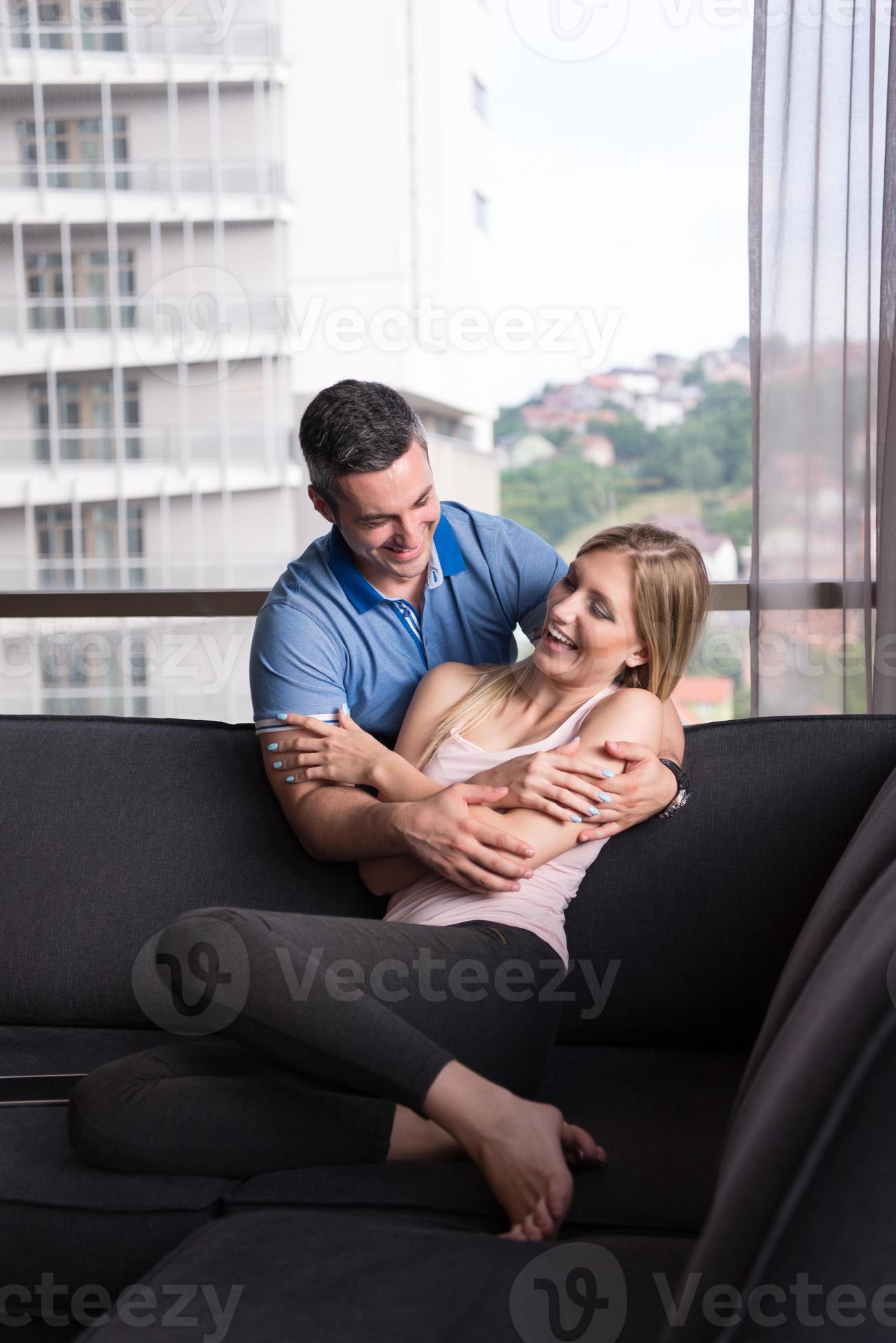 young handsome couple hugging on the sofa 10799073 Stock Photo at Vecteezy