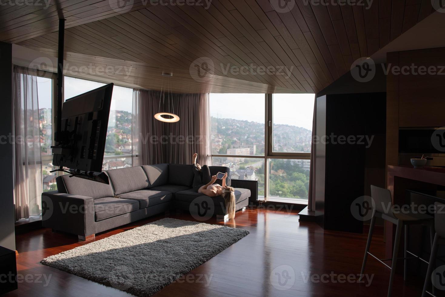 Lovely Blond Woman Listening To Music while resting on couch photo