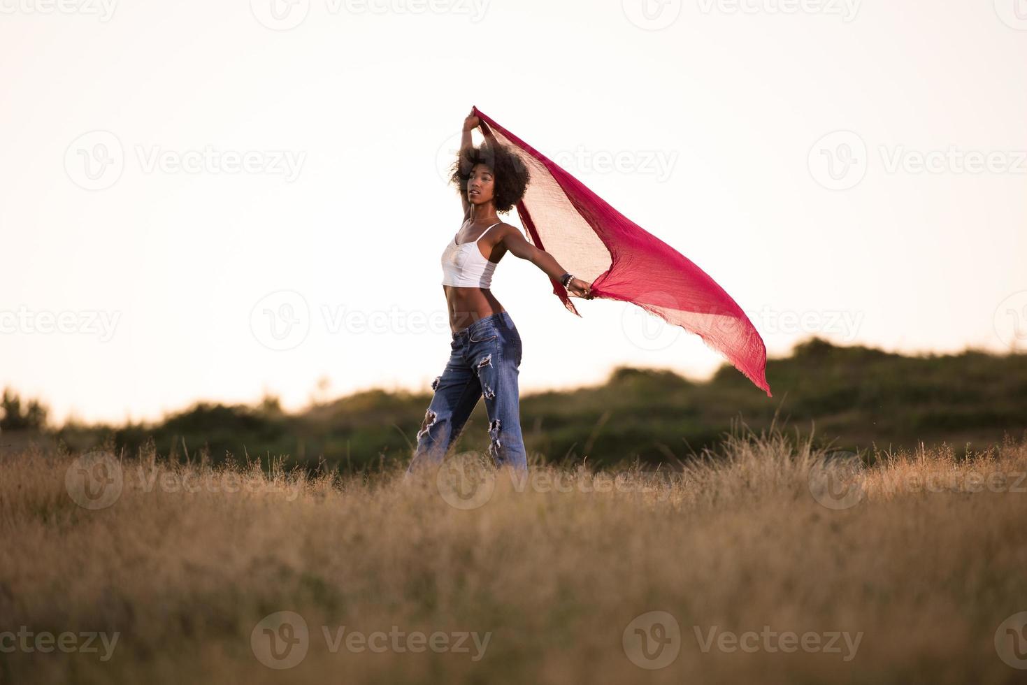 black girl dances outdoors in a meadow photo