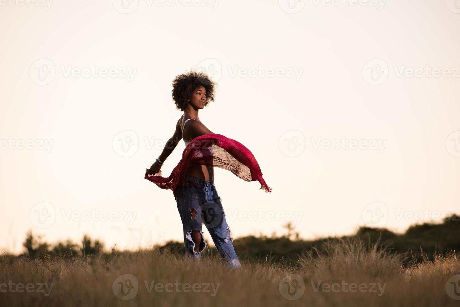 black girl dances outdoors in a meadow photo