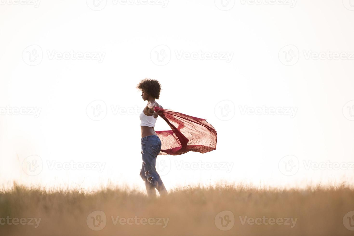 black girl dances outdoors in a meadow photo