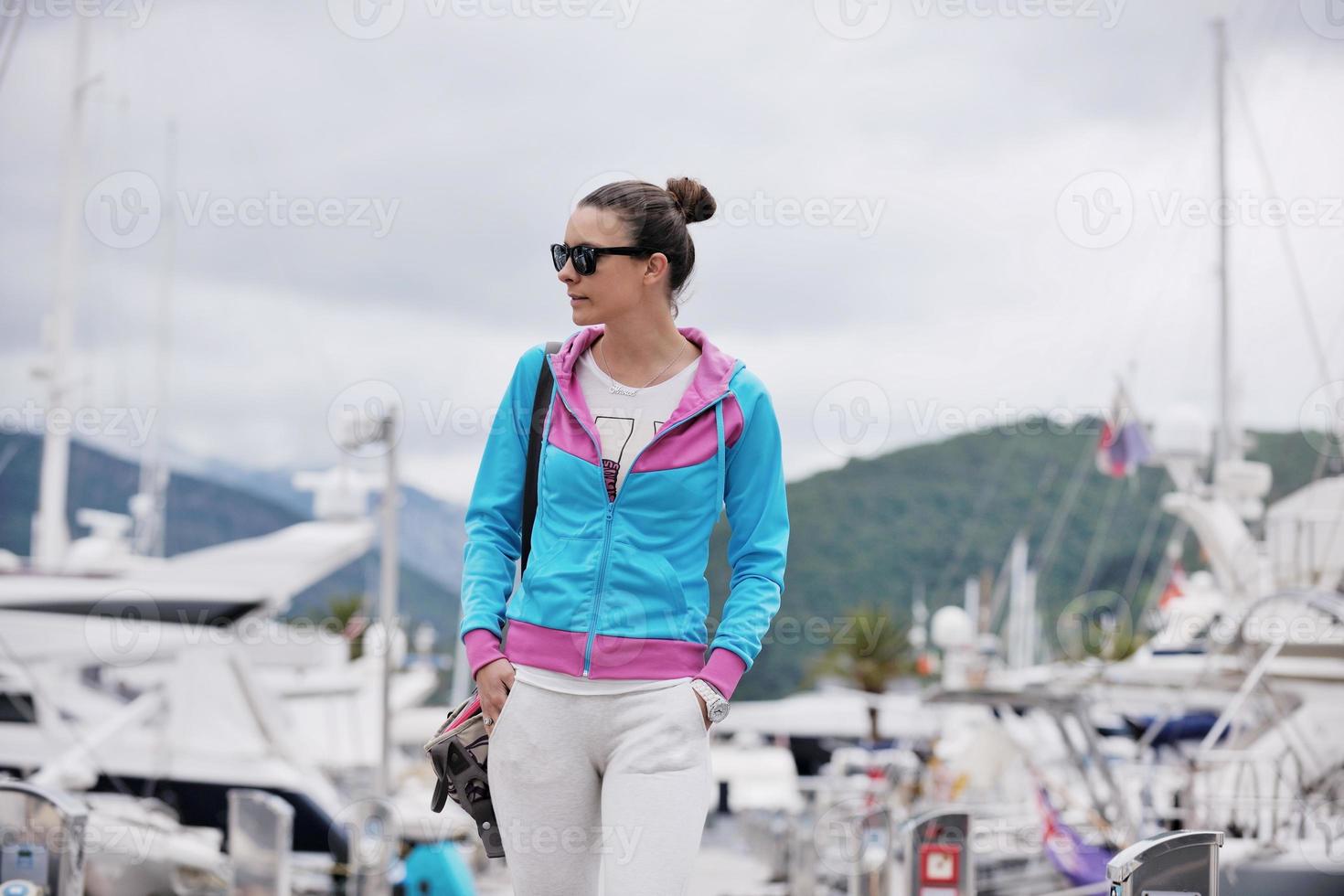 relaxed young woman walking in marina photo