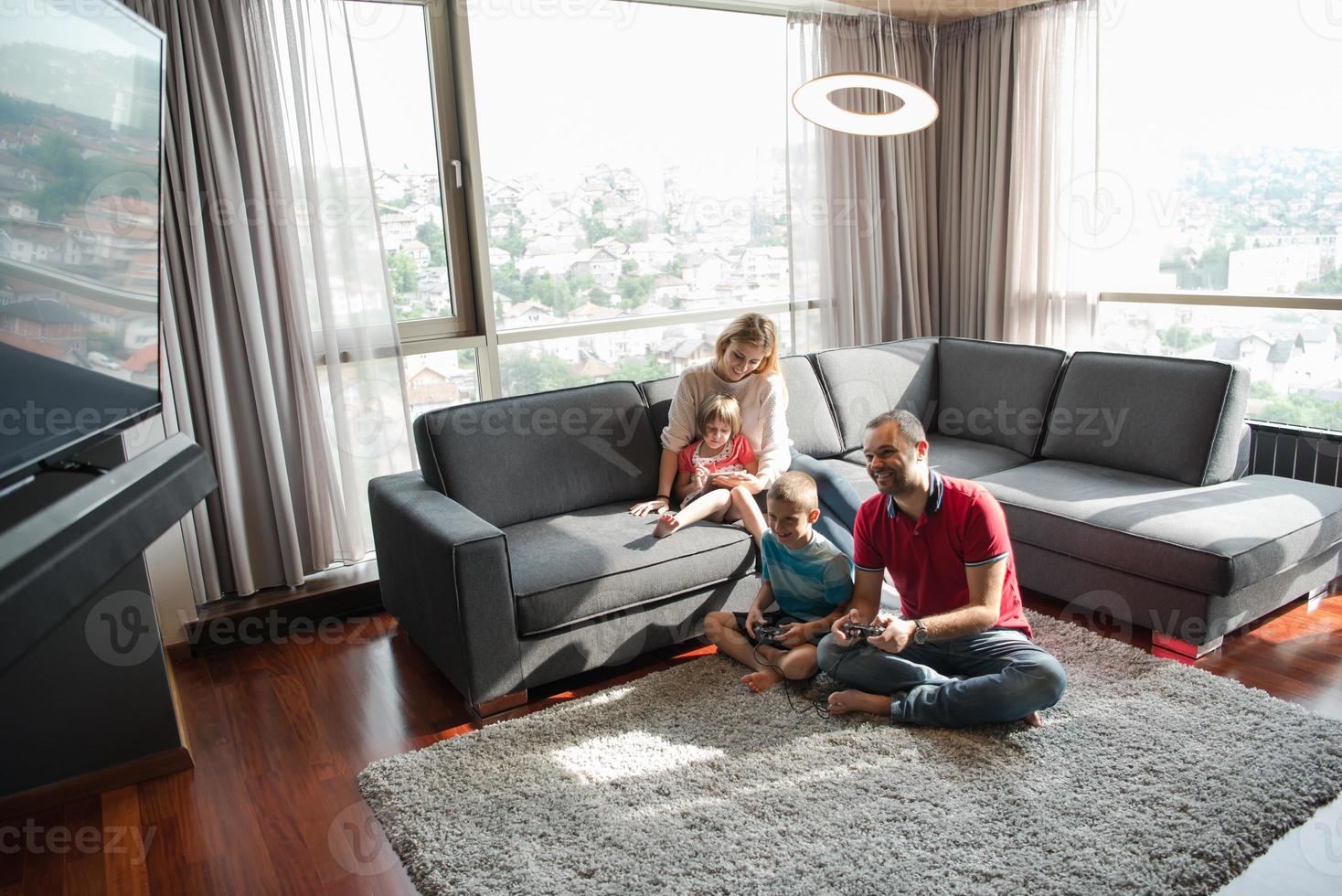 Happy family playing a video game photo