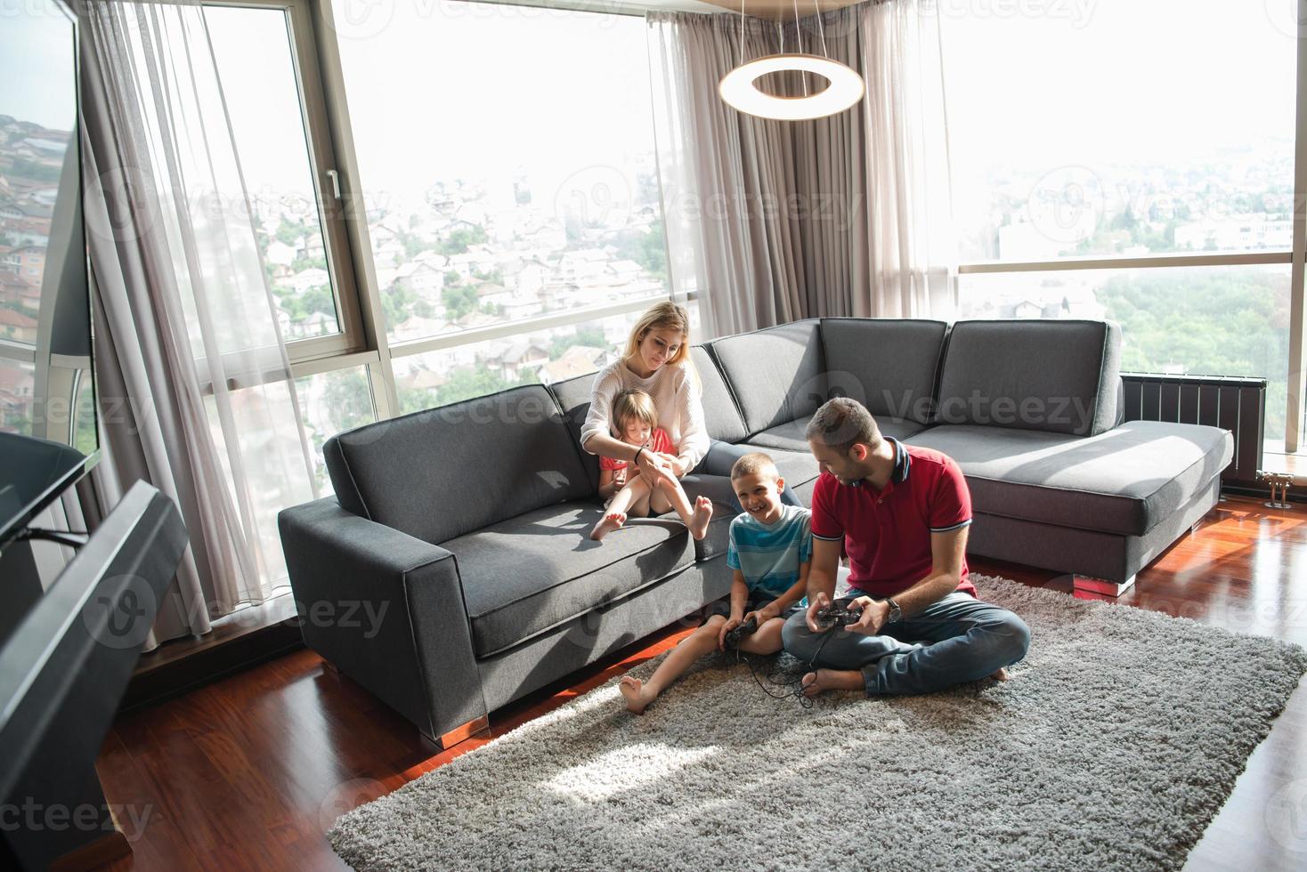 Happy family playing a video game photo