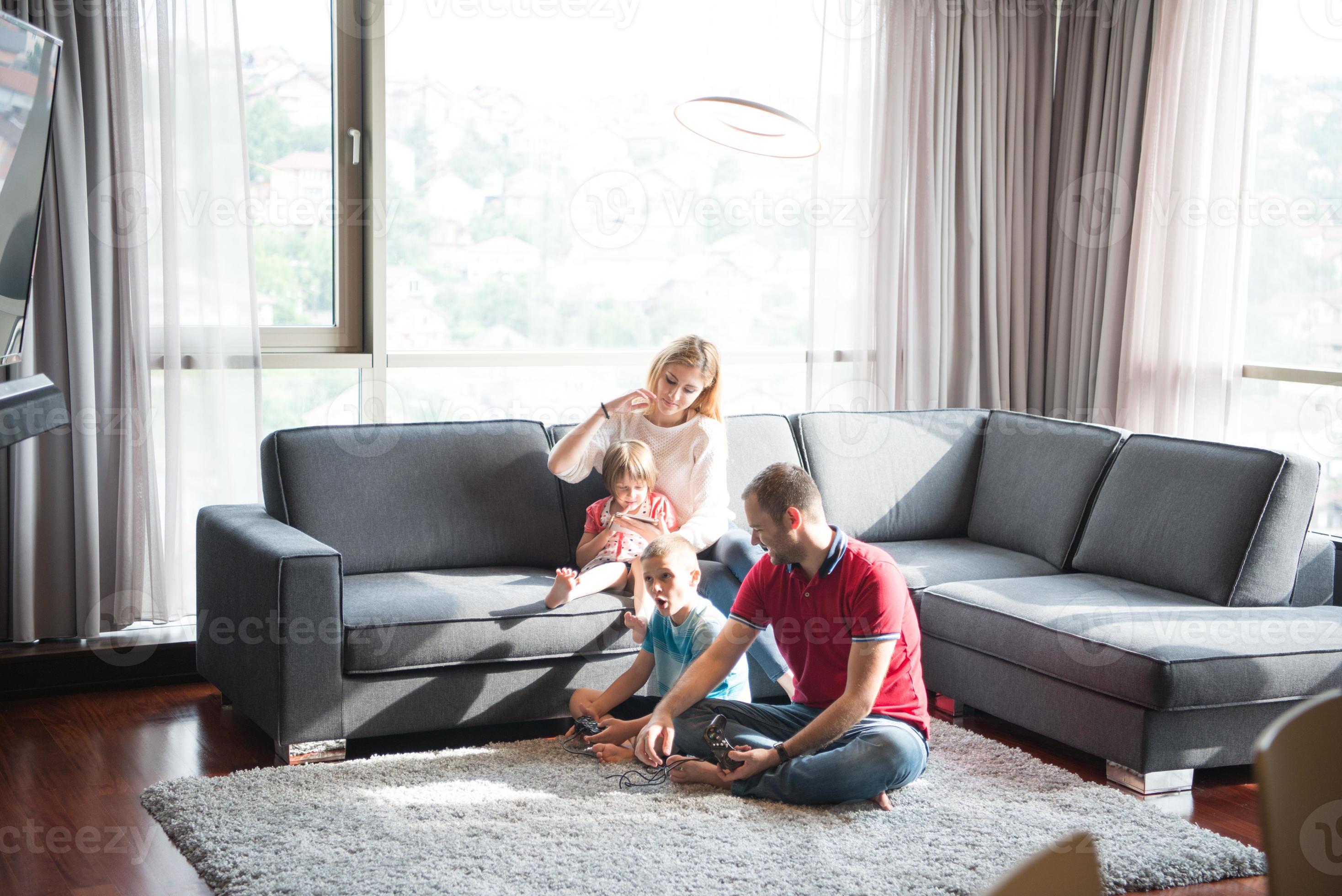 Happy family playing a video game 10800456 Stock Photo at Vecteezy