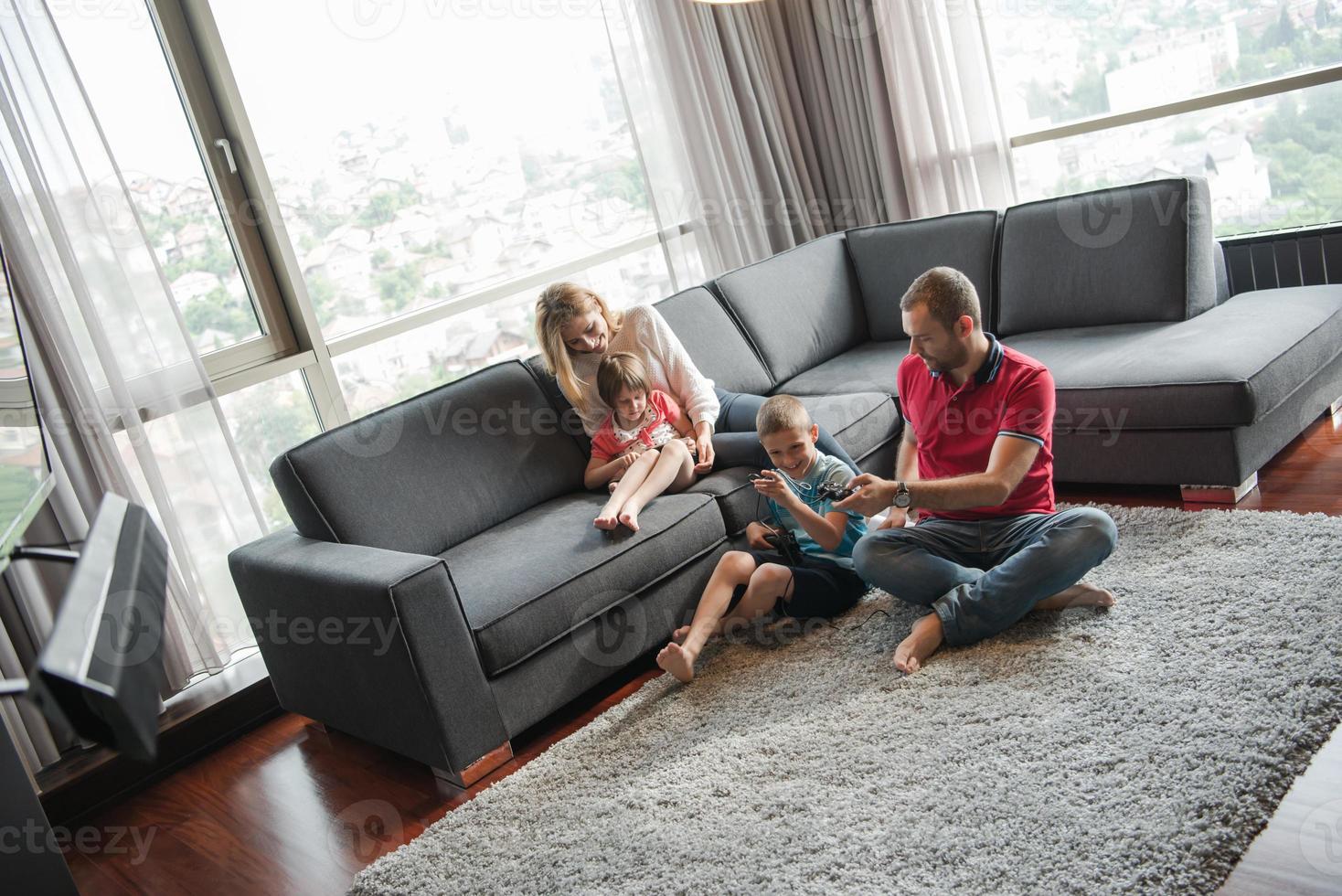 Happy family playing a video game photo