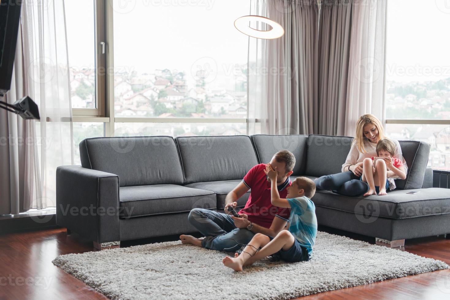 Happy family playing a video game photo