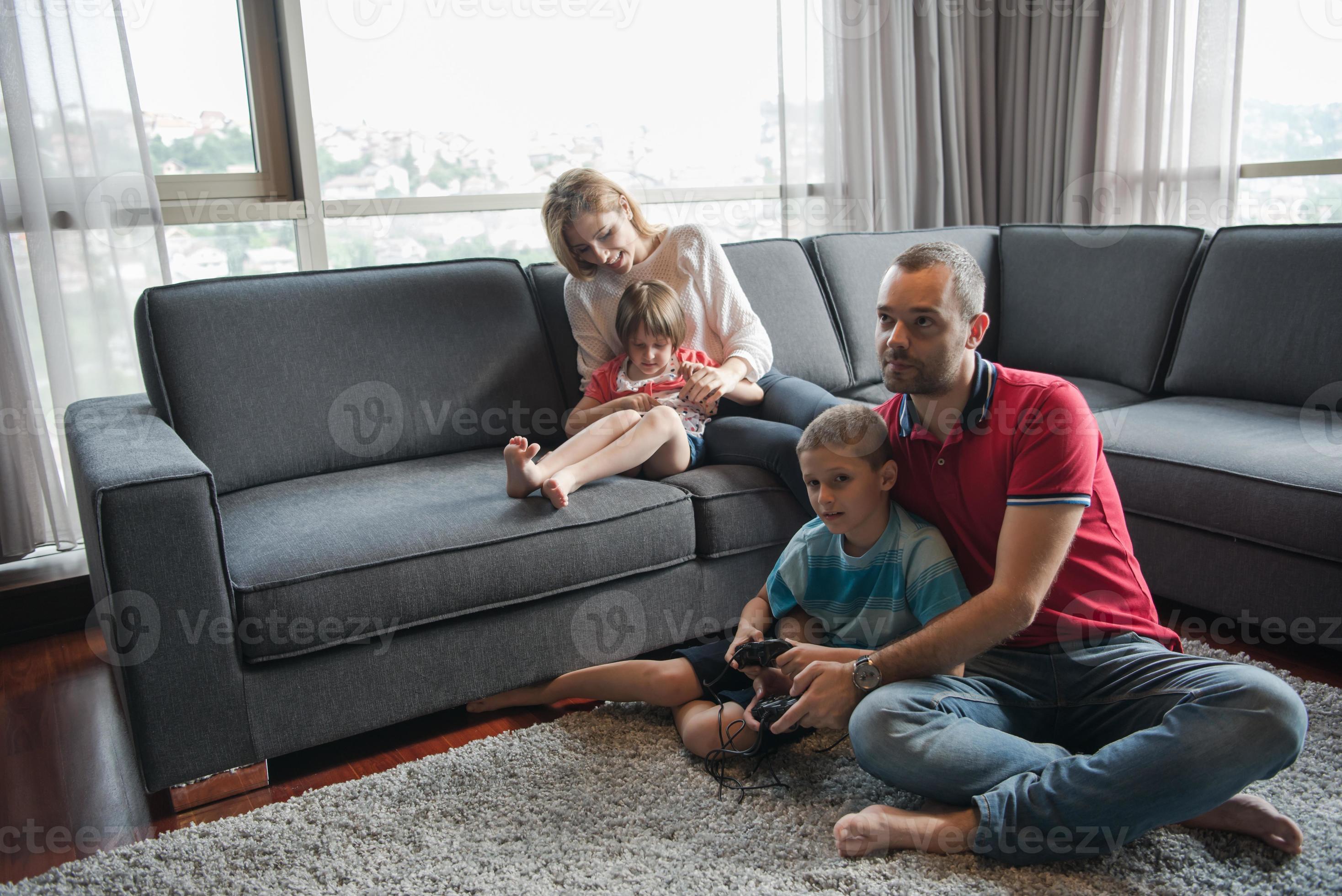 Happy family playing a video game 10801289 Stock Photo at Vecteezy