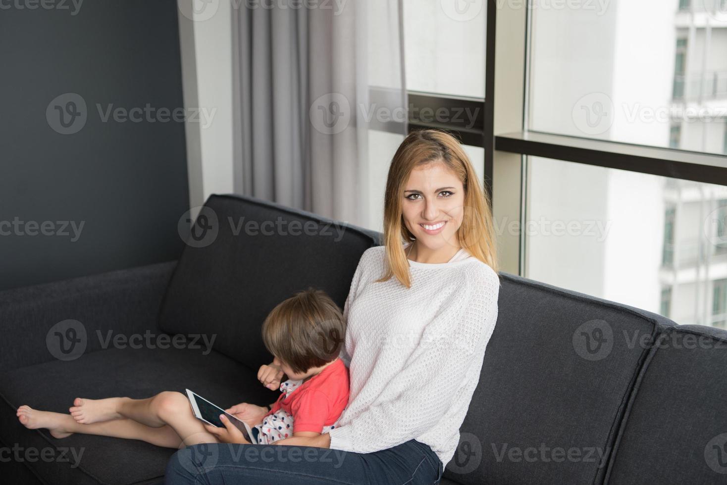 mother and her cute little daughter are using a tablet photo