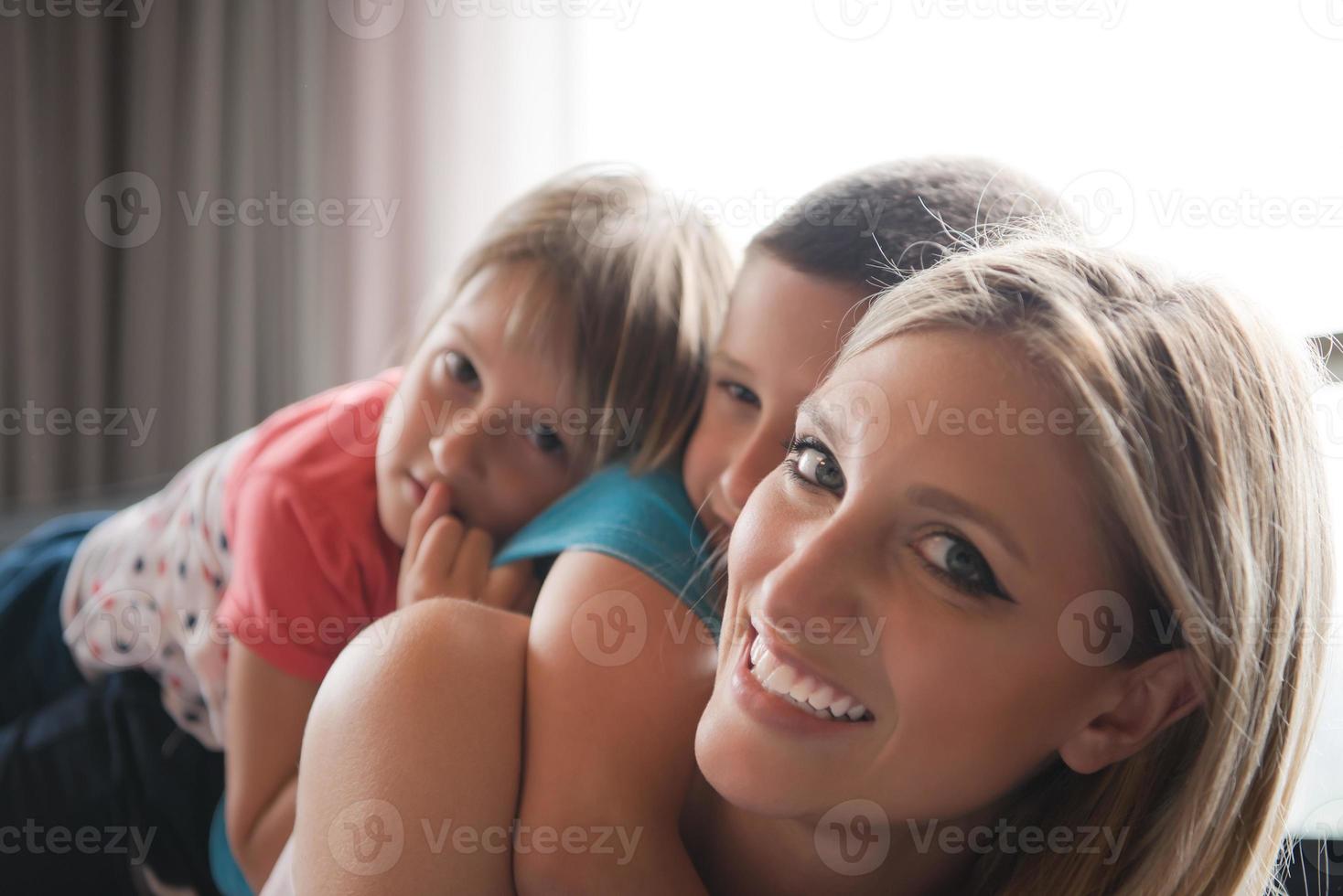 young mother spending time with kids on the floor photo