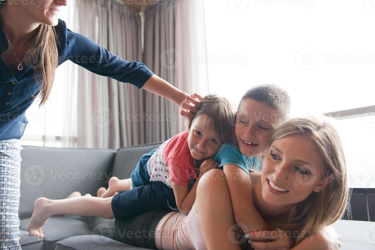 young mother spending time with kids on the floor photo