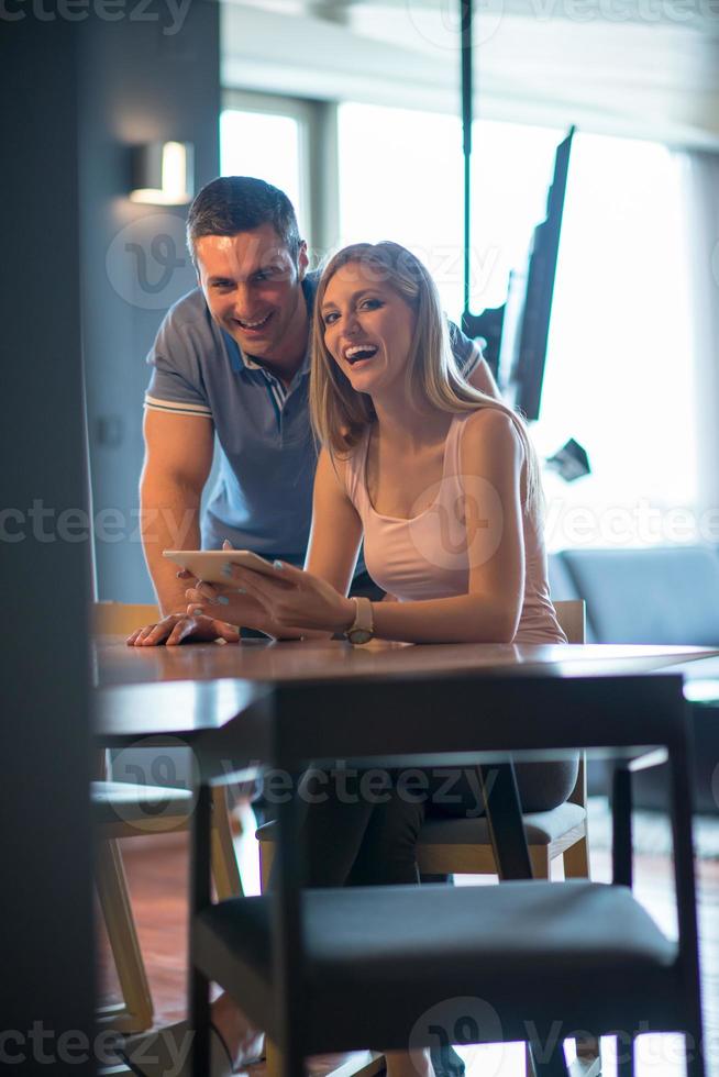 couple using tablet at home photo