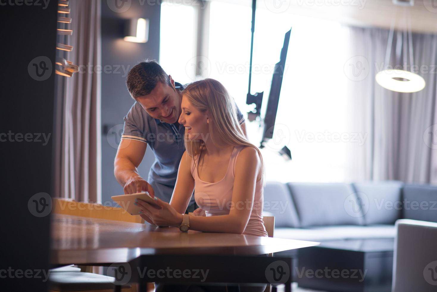 couple using tablet at home photo