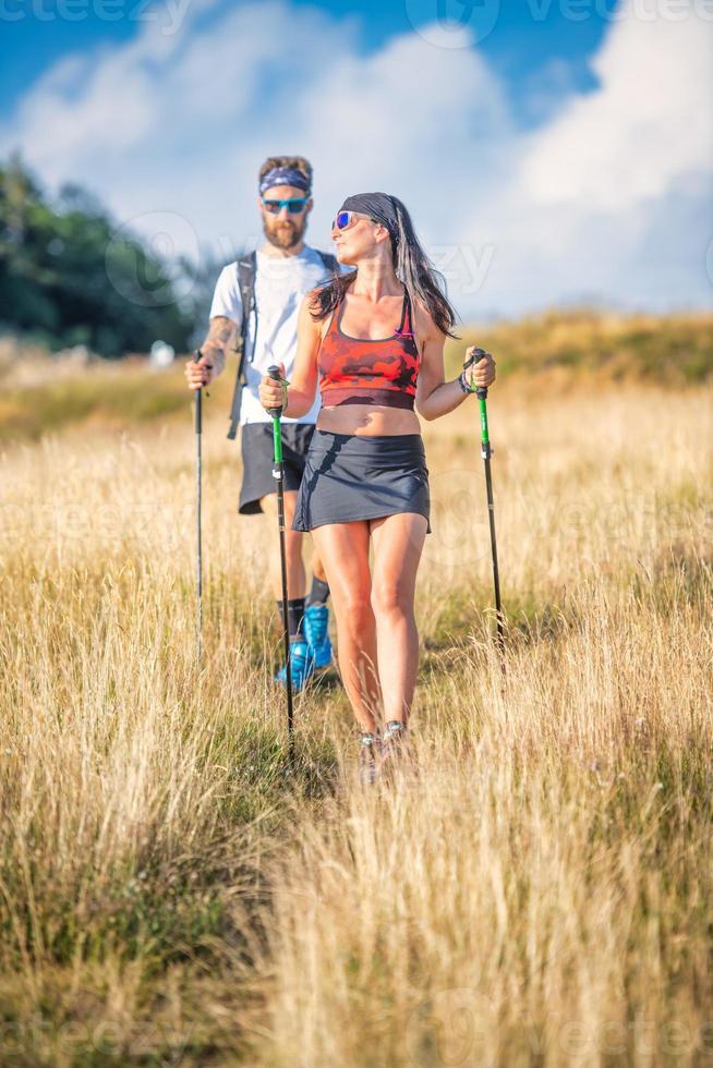 Couple of sportsmen during nordic walking exercise photo