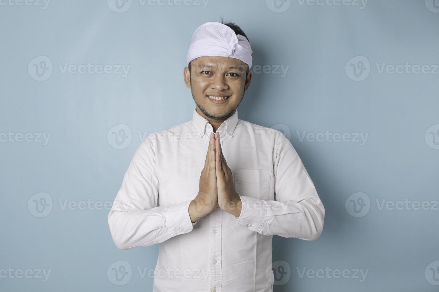 Smiling young Balinese man wearing udeng or traditional headband and