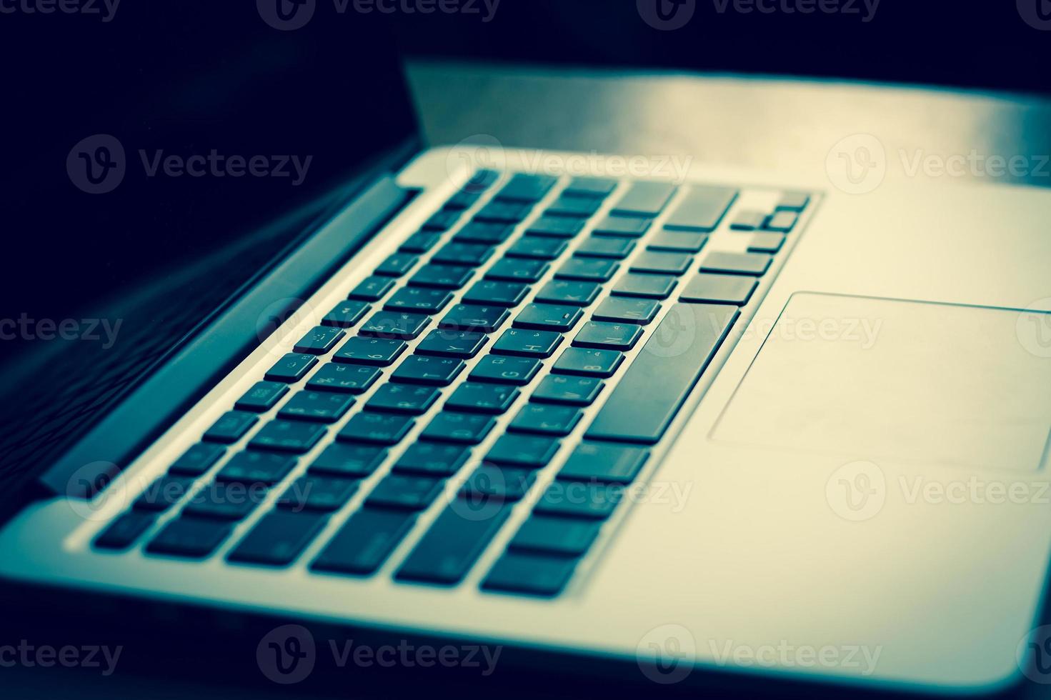 open laptop with black screen on modern wooden desk photo