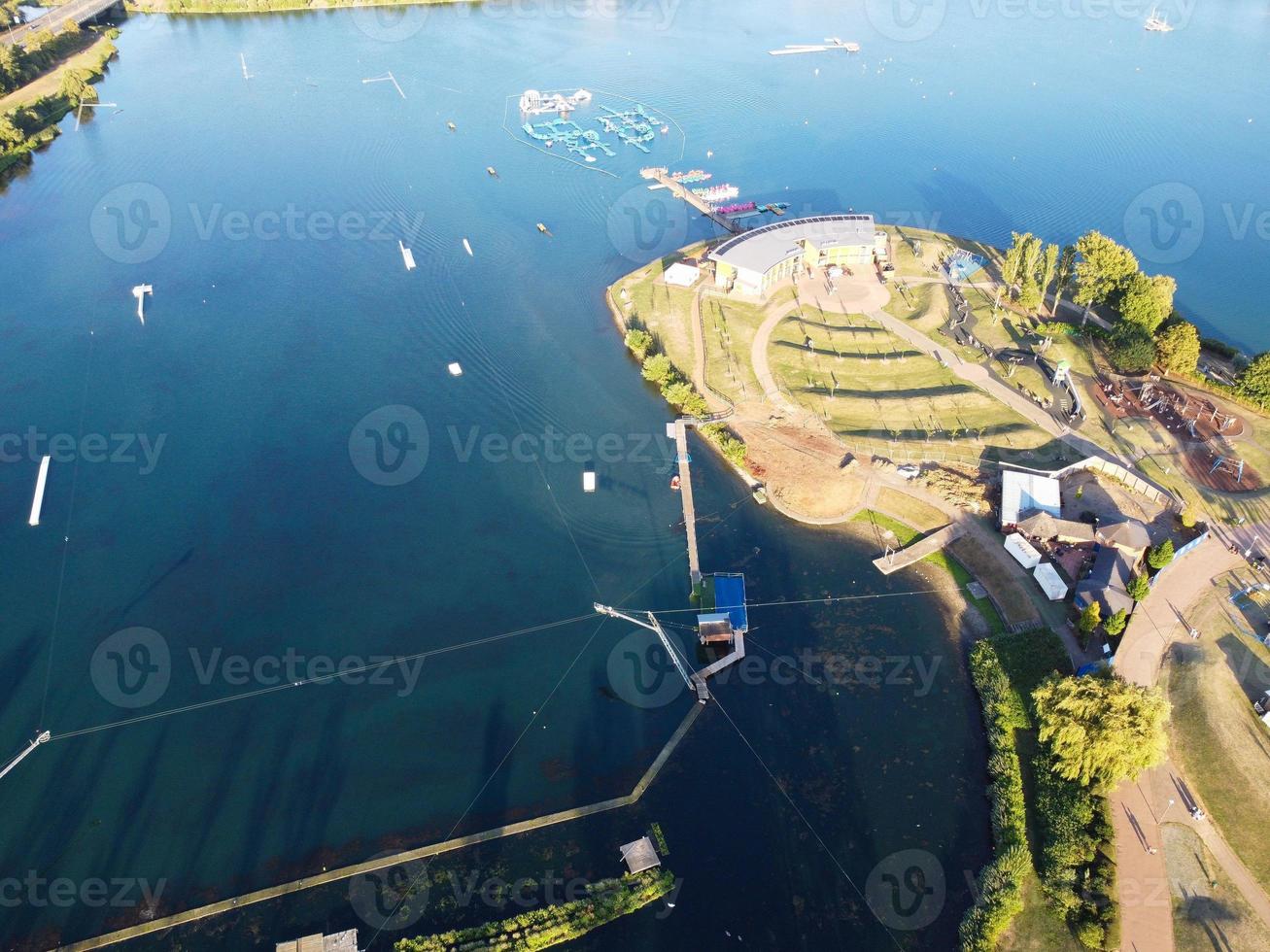 Beautiful Aerial Drone's Camera  Footage of Willen Lake and Park which is located at Milton Keynes, England. People are Enjoying at Lake on a Hot Sunny Day of Summer photo