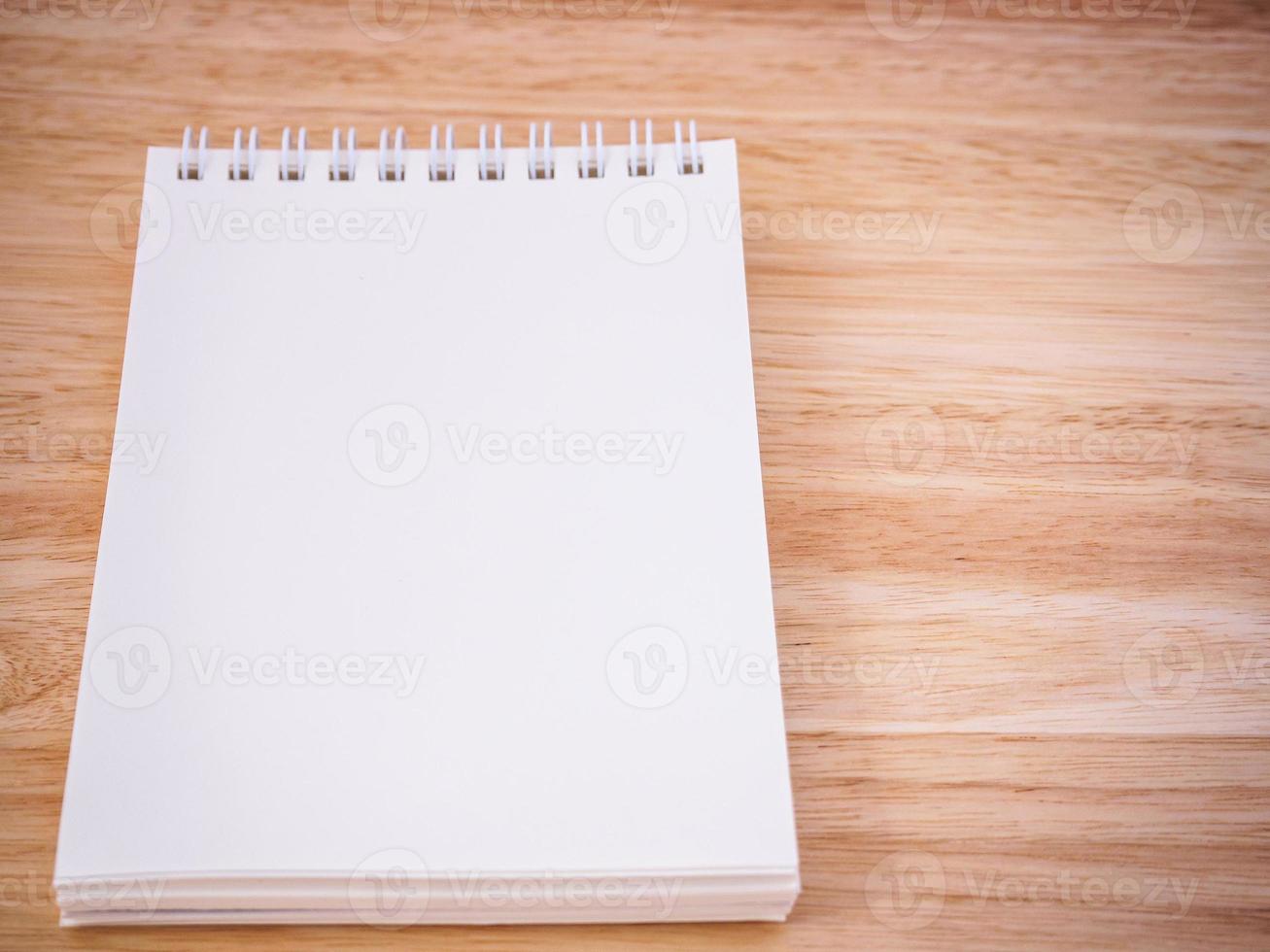 Notepad on the wooden desk table photo