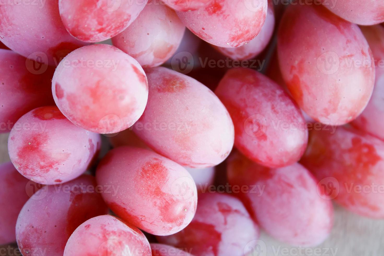 red grapes on wooden background photo