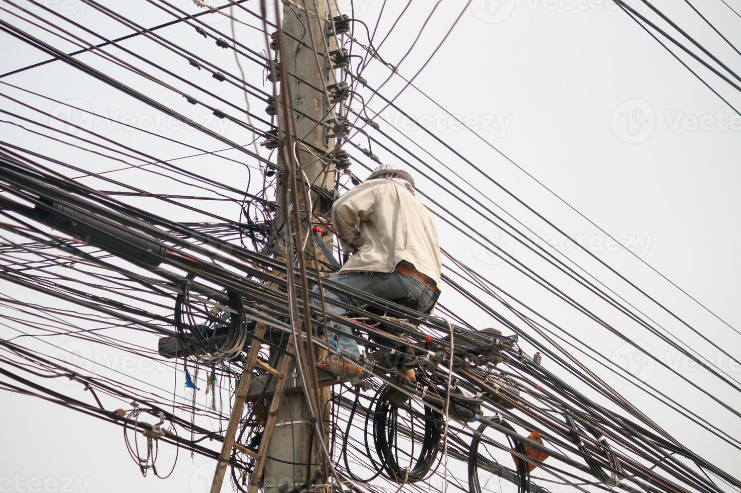 Electrician on electric poles photo