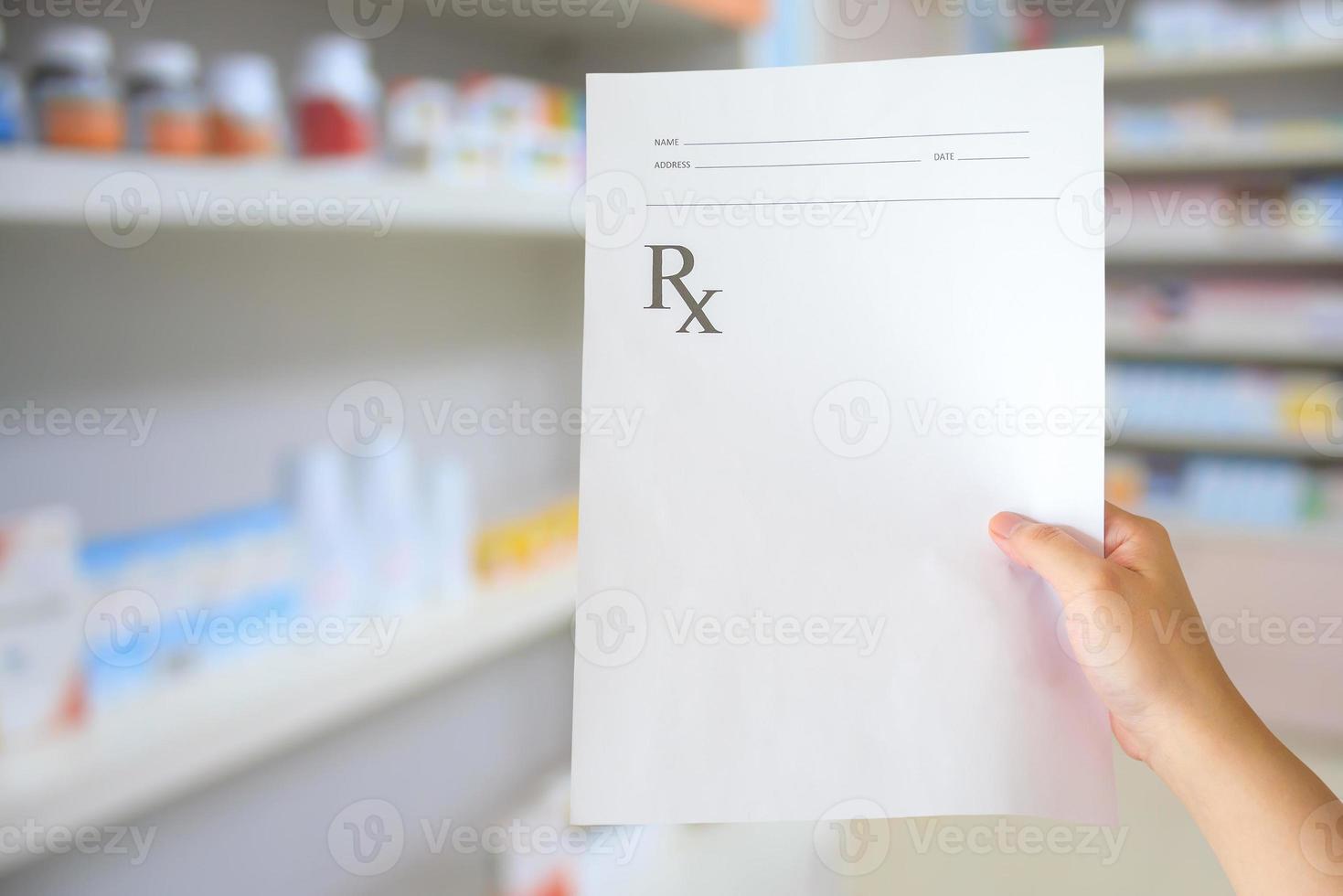 pharmacist with prescription at the pharmacy photo