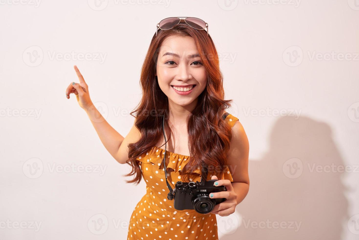 Joyful girl traveler curiously pointing to the sky photo