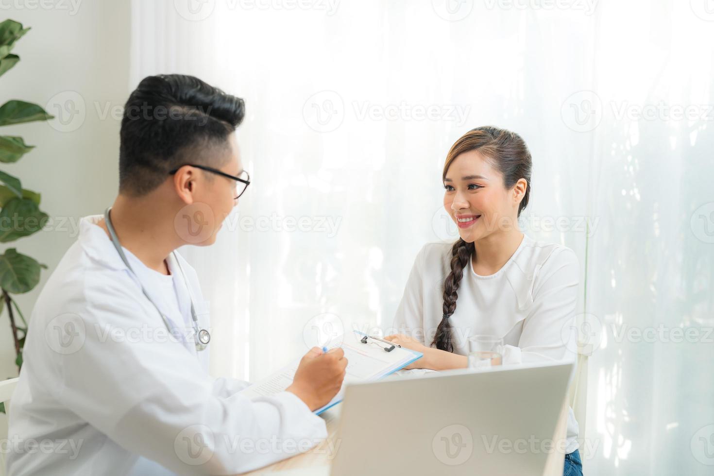 Woman patient consulting with doctor or psychiatrist on obstetric - gynaecological female illness, or mental health in medical clinic or hospital healthcare service photo