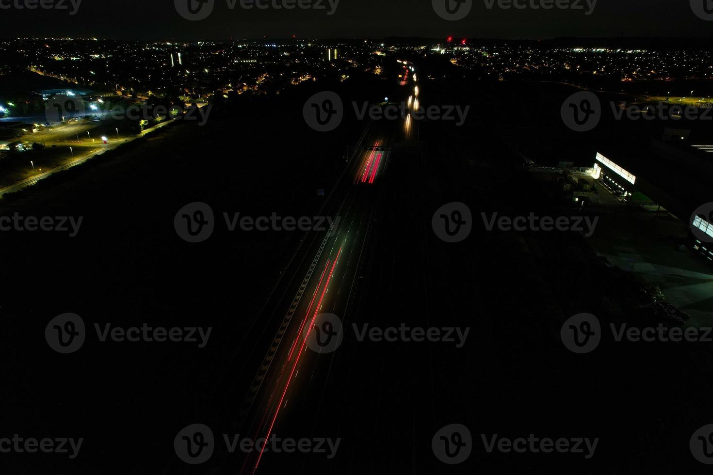 Night Aerial View of British Motorways with illuminated Roads and Traffic. Highways footage taken with drone's camera over Milton Keynes and motorways of England at Dark Night photo