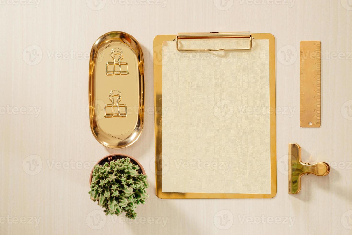 Women's home office workspace with clipboard, macaroons, pen, coffee mug on pastel background. Flat lay, top view lifestyle concept. photo