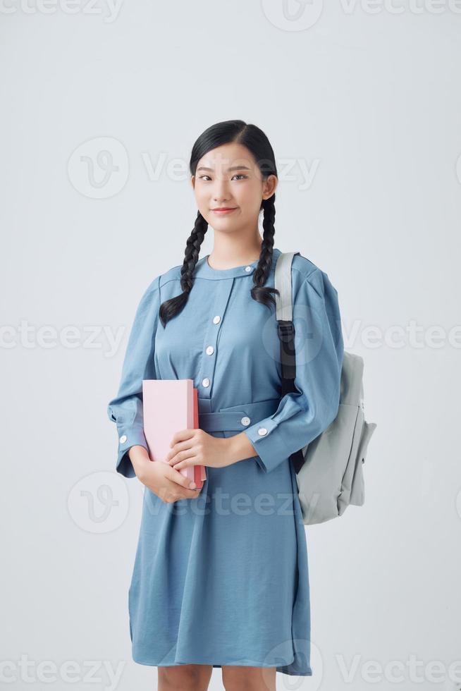 Young Asian student isolated on white background. photo