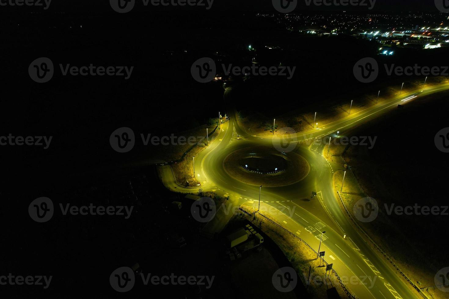 Night Aerial View of British Motorways with illuminated Roads and Traffic. Highways footage taken with drone's camera over Milton Keynes and motorways of England at Dark Night photo