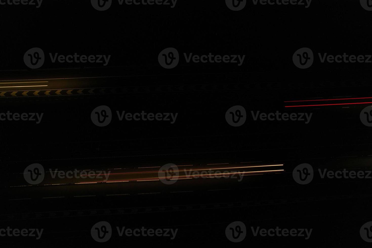 Night Aerial View of British Motorways with illuminated Roads and Traffic. Highways footage taken with drone's camera over Milton Keynes and motorways of England at Dark Night photo