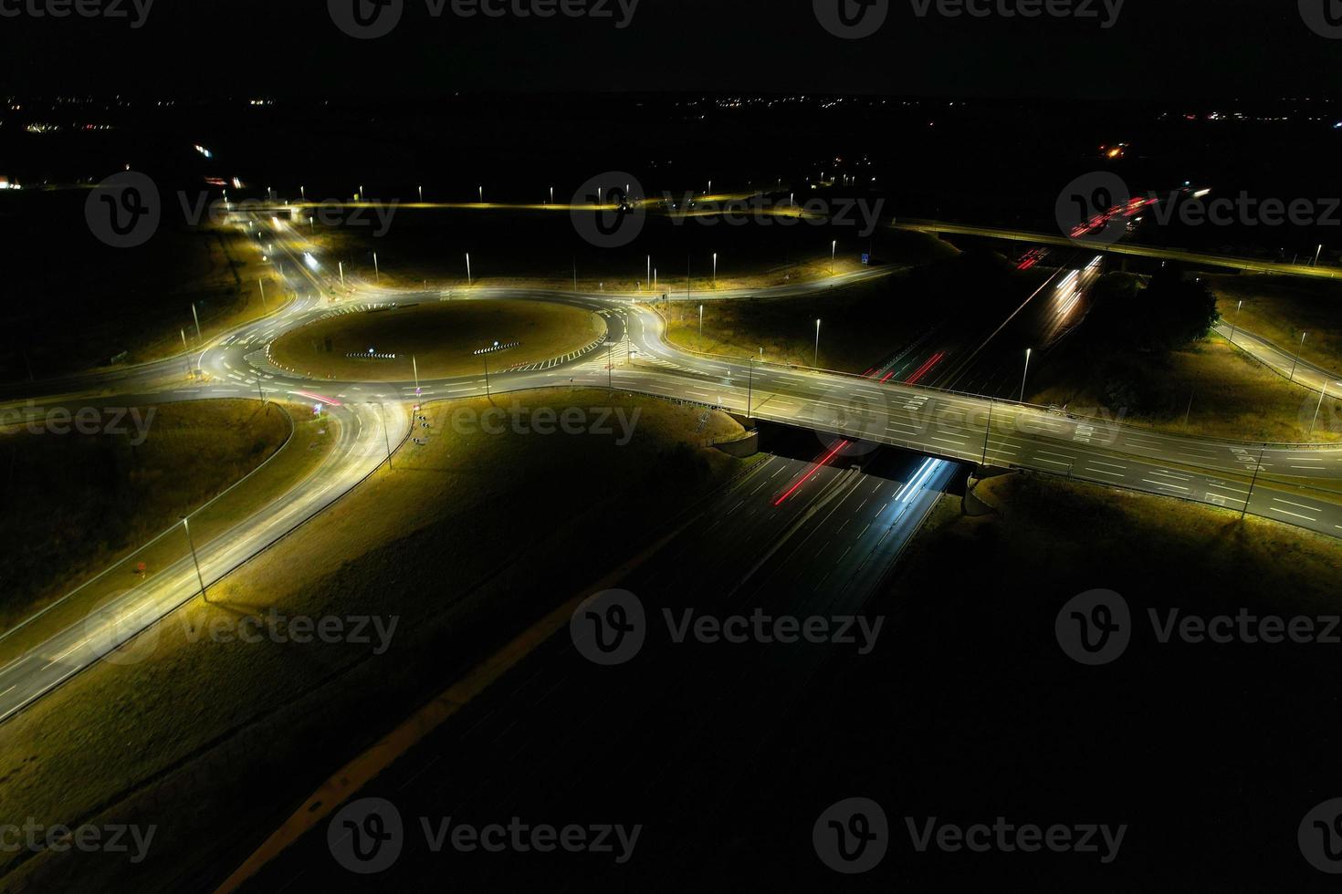 Night Aerial View of British Motorways with illuminated Roads and Traffic. Highways footage taken with drone's camera over Milton Keynes and motorways of England at Dark Night photo