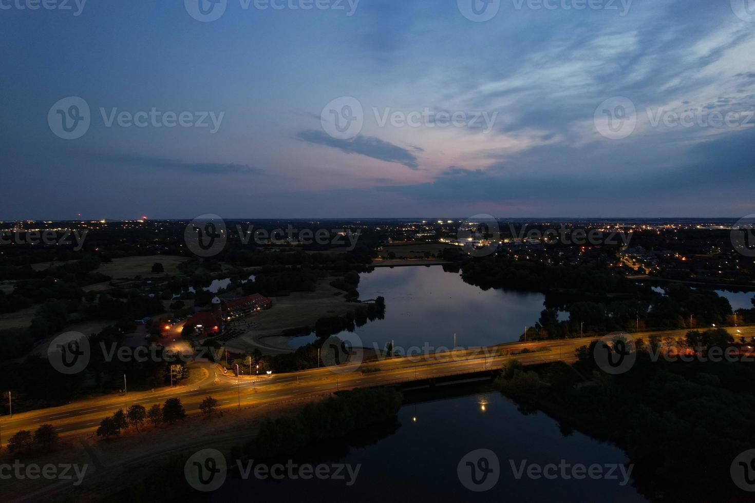 Night Aerial View of British Motorways with illuminated Roads and Traffic. Highways footage taken with drone's camera over Milton Keynes and motorways of England at Dark Night photo