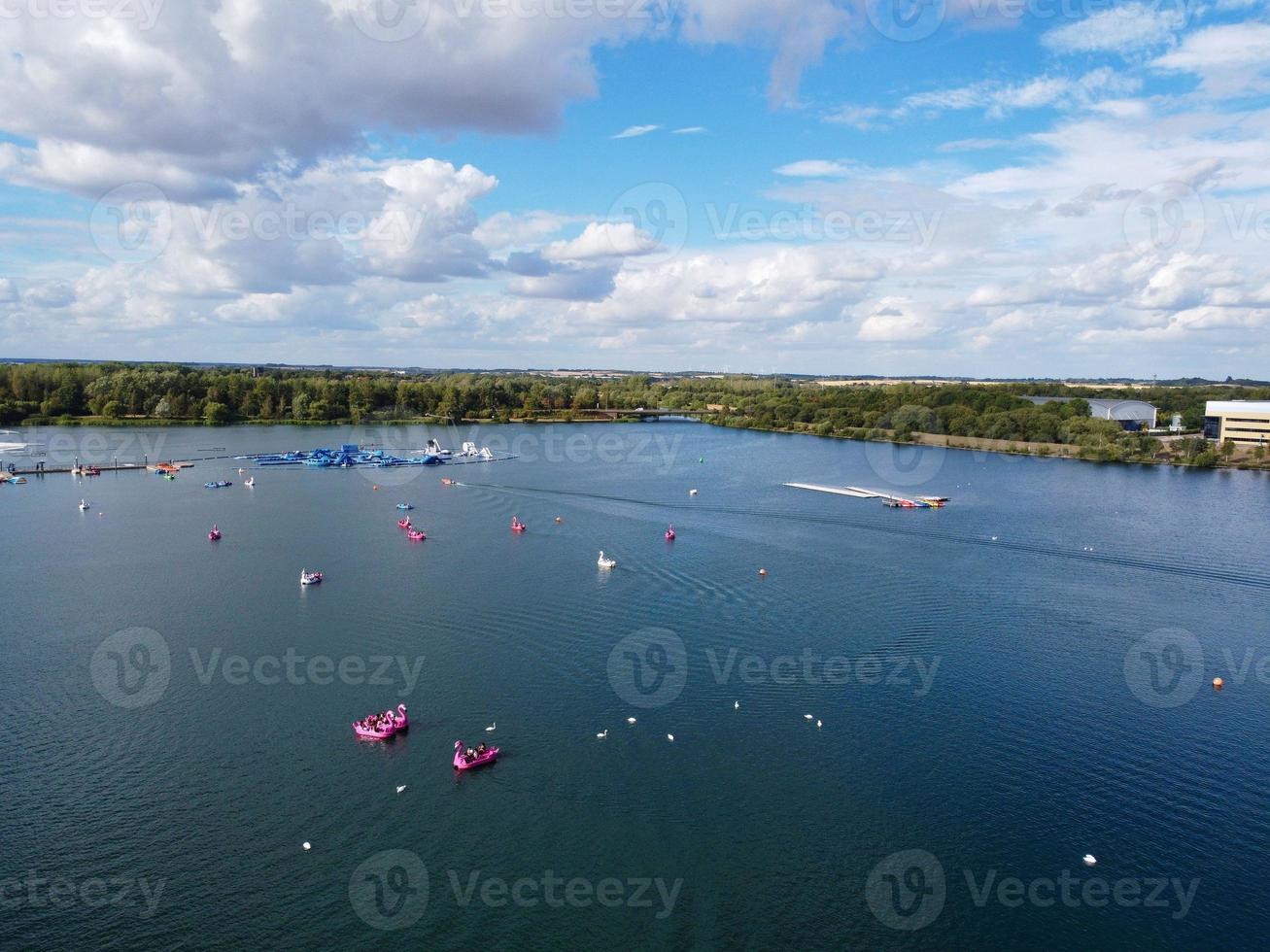 Beautiful Aerial Drone's Camera  Footage of Willen Lake and Park which is located at Milton Keynes, England. People are Enjoying at Lake on a Hot Sunny Day of Summer photo