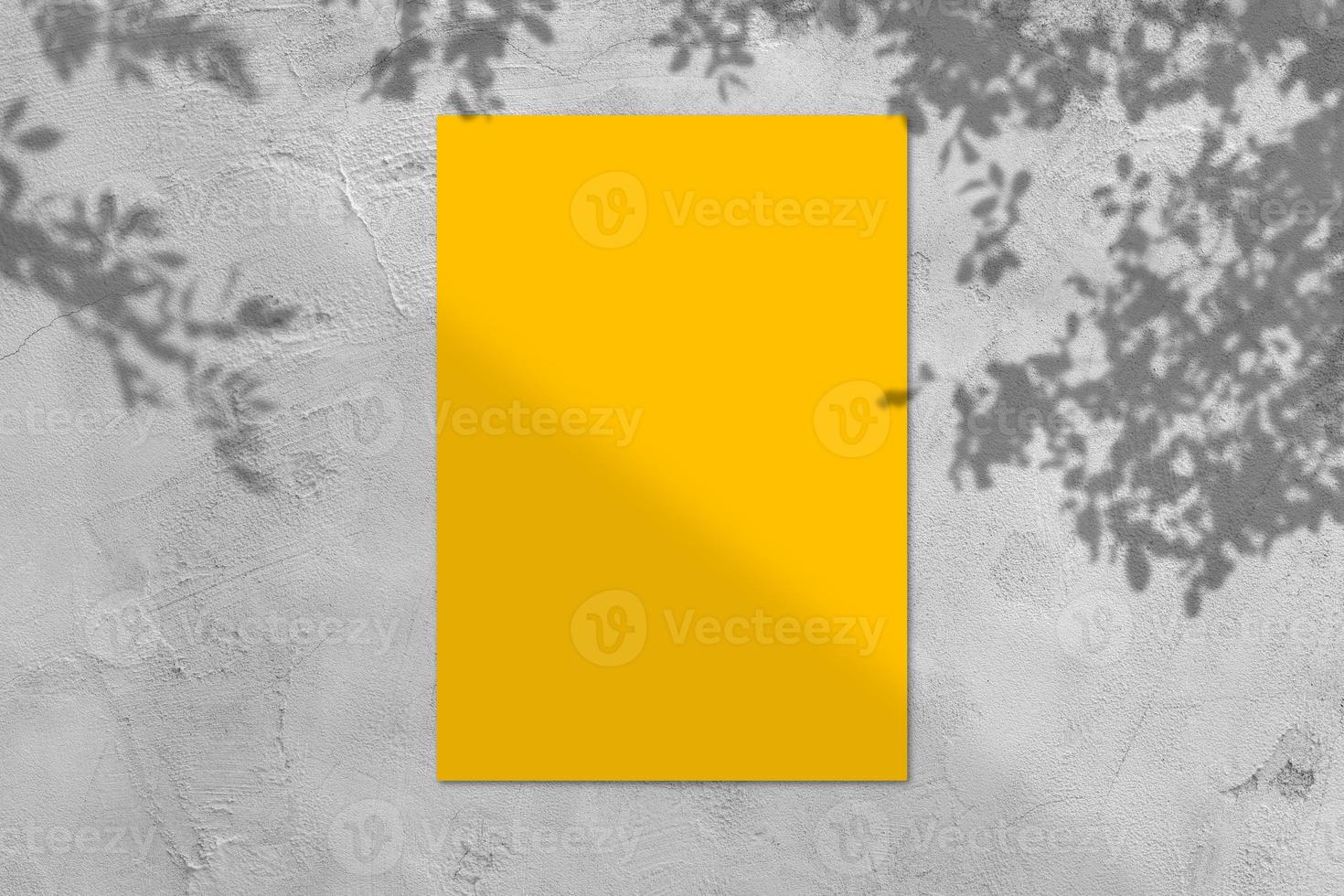 Empty yellow square poster mockup with light shadow on gray concrete wall background. photo