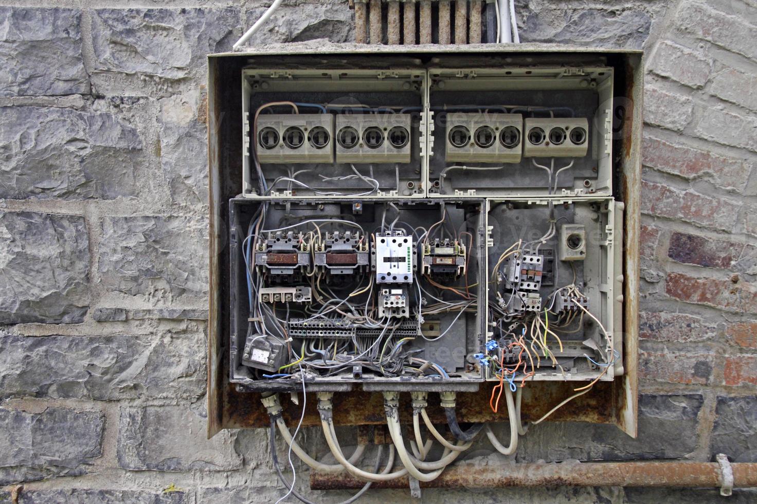 Open fuse box and chaotic cables photo