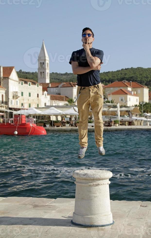 Man seemingly floating mid-jump on the island of Brac, Croatia photo