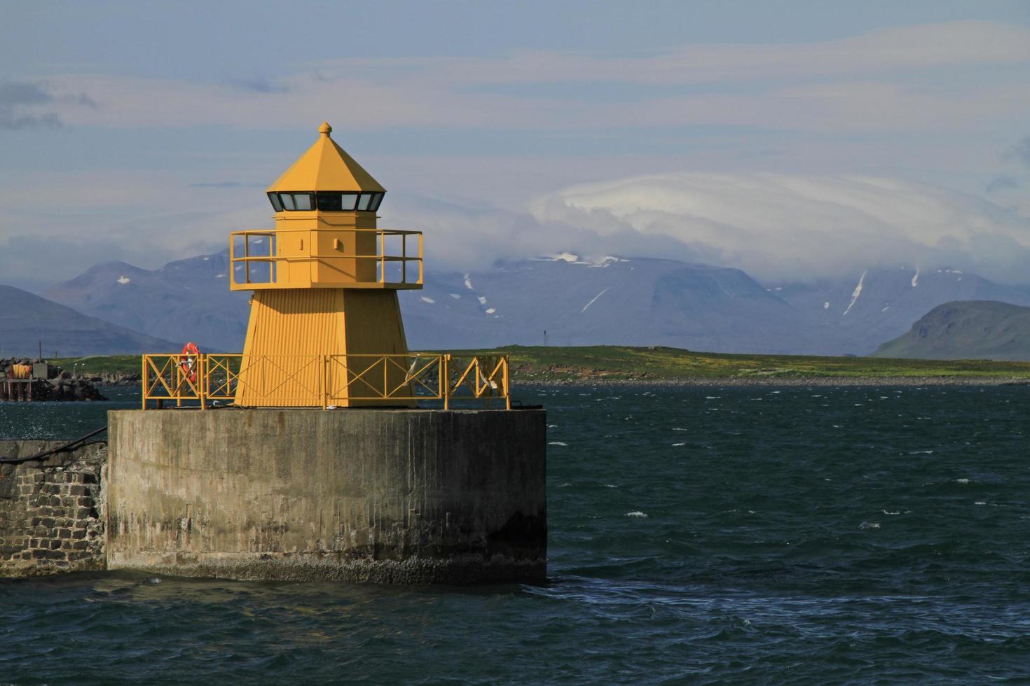 Reykjavik, Iceland, 2019 - Yellow light house at the harbor of Reykjavik, Iceland photo