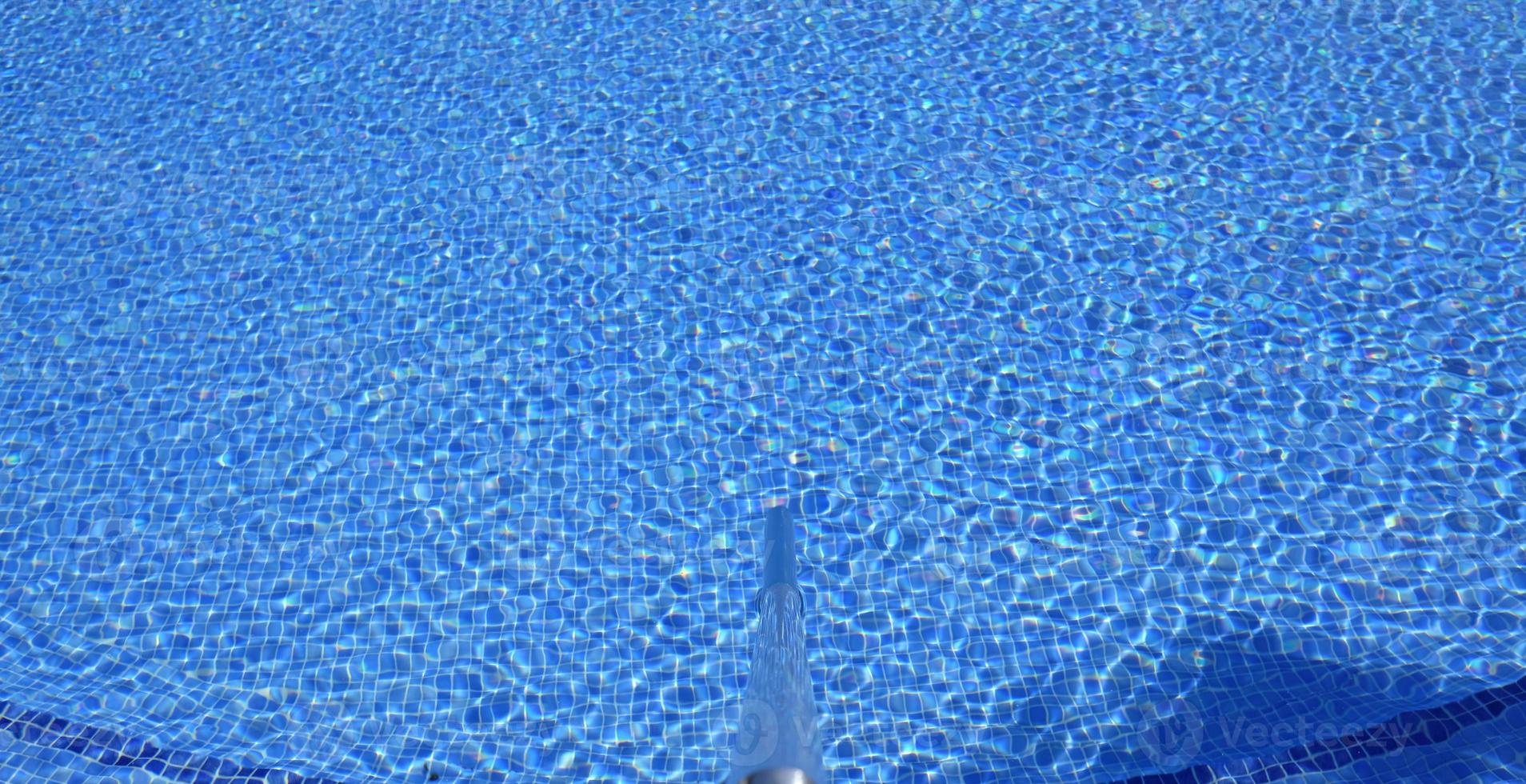 Ripples on the surface of an outdoor pool on a sunny day photo