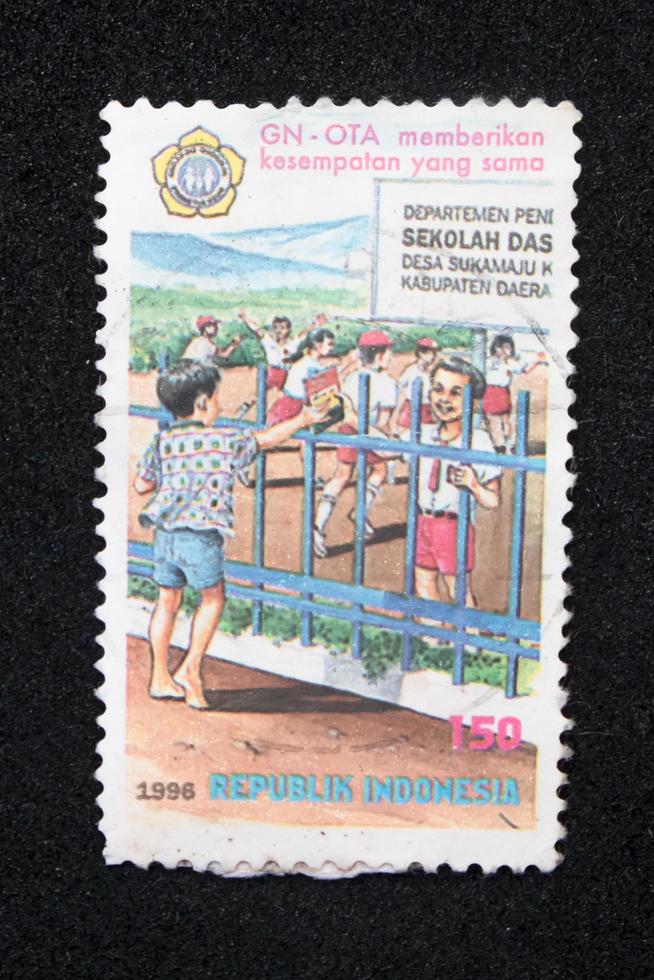 Sidoarjo, Jawa timur, Indonesia, 2022 -  philately with the theme of an illustration of a boy wanting to learn photo