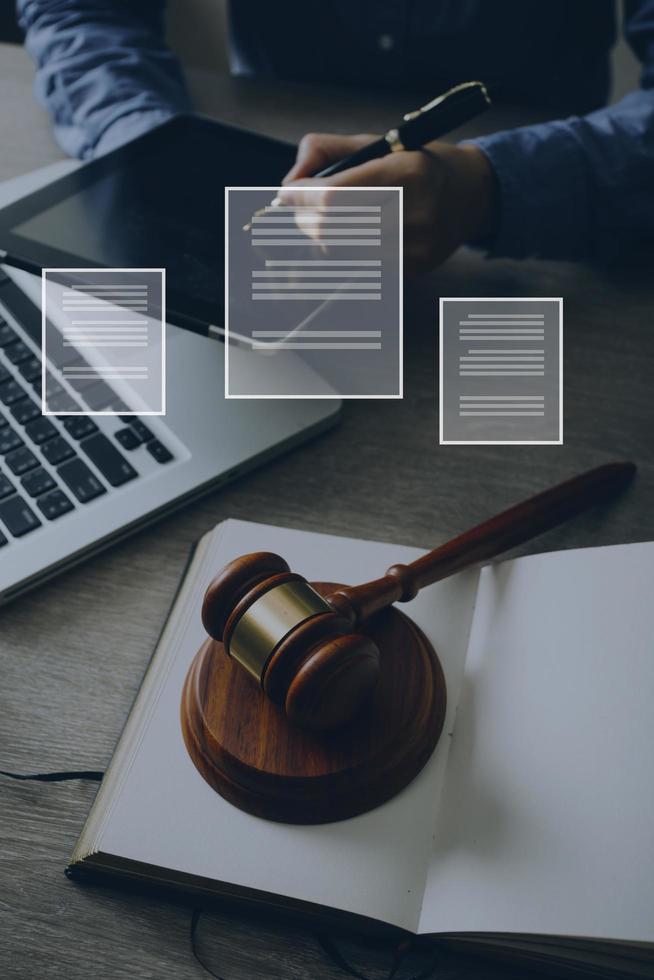 Male lawyer working with contract papers and wooden gavel on tabel in courtroom. justice and law ,attorney, court judge, concept. photo